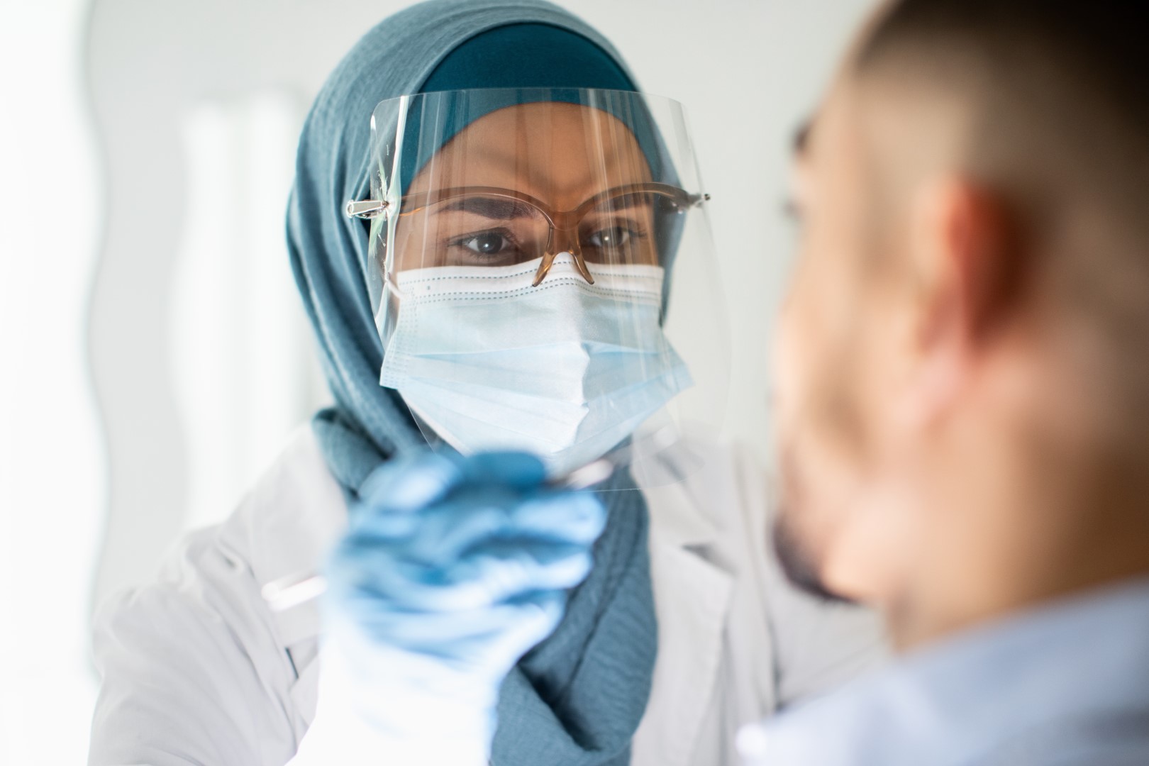 Covid-19 Testing 2 islamic dentist lady in hijab and face shield exam 2023 11 27 04 52 54 utc Large